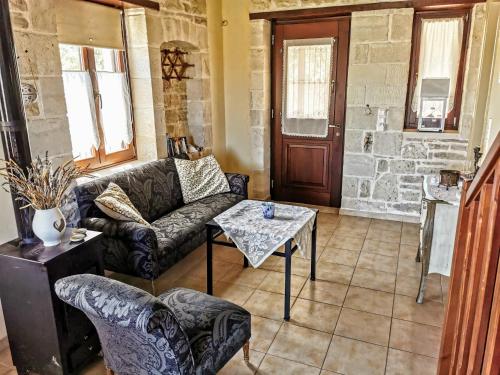 a living room with a couch and a table at Aelia in Kamilari