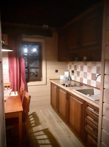 a kitchen with a sink and a counter top at Садиба Остра in Sherbovtsy