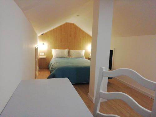 a small room with a bed and a table at The Best House in Bragança