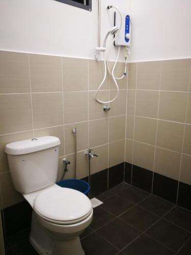 a bathroom with a toilet and a phone on the wall at LeCamar STAYCATION Swimming Pool and Fully Air-conditioned at Bukit Katil 4 Queen-sized Bed and 3 Single-sized Bed in Malacca