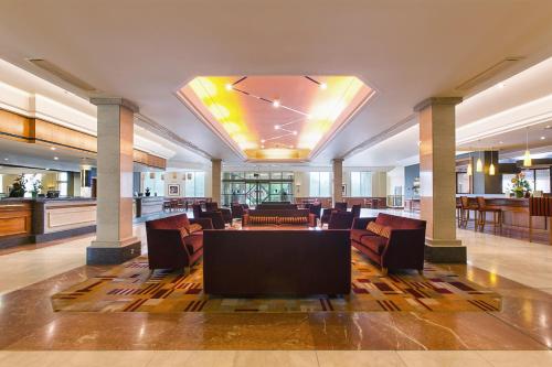a lobby with chairs and a table in a building at Mercure Daventry Court Hotel in Daventry