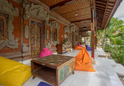 a room with colorful furniture and a building at Nushe Hostel in Nusa Penida