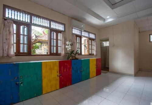 a room with a colorful counter in a room with windows at Nushe Hostel & Room in Nusa Penida