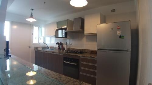 a kitchen with a stainless steel refrigerator and cabinets at GL Apts, rent Upper Pardo Miraflores - Suite 1 Hab in Lima