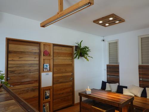 a room with a wooden door and a table at Summerflow Hostel in Xiaoliuqiu