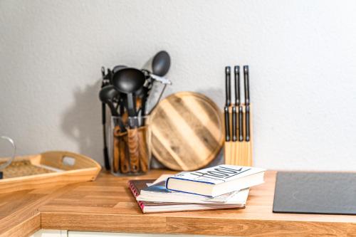 a wooden table with books and utensils on it at stuub langenbach in Titisee-Neustadt