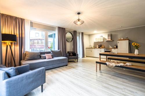a living room with two couches and a table at stuub langenbach in Titisee-Neustadt