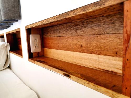 a wooden wall with a lightswitch next to a couch at Summerflow Hostel in Xiaoliuqiu