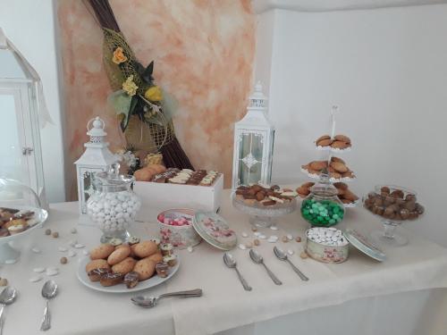 a table with plates of food and desserts on it at Hotel Resort Nuraghe Arvu in Cala Gonone
