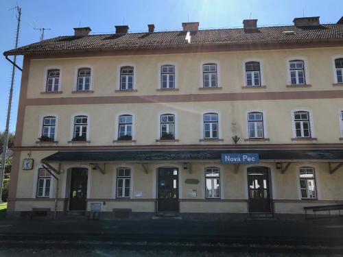 a large building with a sign in front of it at Apartmán u jezera Lipno - Nové in Nová Pec