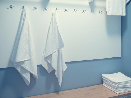 a towel rack with stars on a blue wall at Kamanos in Utena