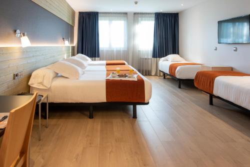 מיטה או מיטות בחדר ב-Hotel Avenida