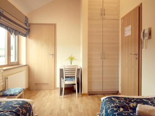 a bedroom with a desk and a chair and a table at Kamanos in Utena
