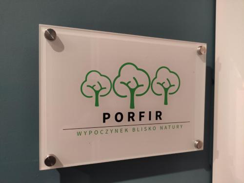a sign for the front of a restroom with trees at Trzy Małe Drzewka in Wielka Wieś