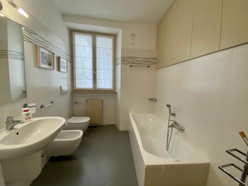 a bathroom with two toilets and a sink and a tub at Fontana di San Giacomo in Bergamo