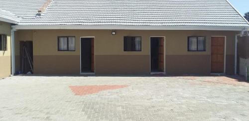 a house with a lot of doors on it at Classic-Lodge in Kempton Park