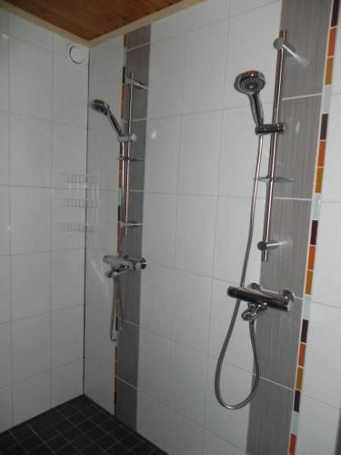 a bathroom with a shower with a shower head at Cottage Elsa in Kuopio