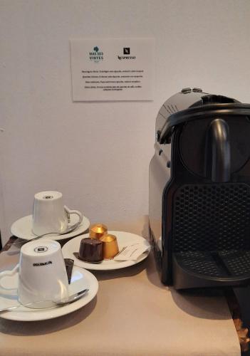 a desk with two plates and a coffee maker at Mas Ses Vinyes - Adults Only in Begur