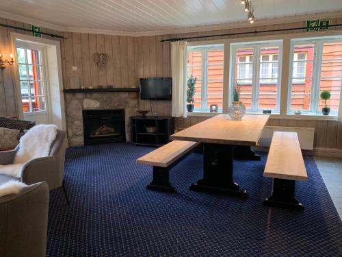 a living room with a table and a fireplace at Tinden in Hemsedal