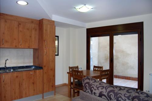 a kitchen and dining room with a table and a couch at Estasía in Sopeira