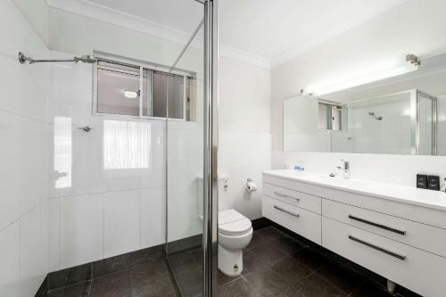 a bathroom with a toilet and a sink and a shower at Quality Inn Ashby House Tamworth in Tamworth