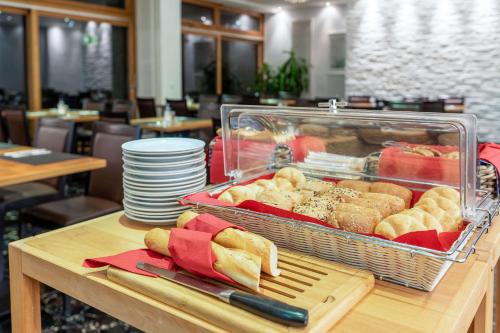 a buffet with a tray of food on a table at Comfort Hotel Atlantic Muenchen Sued in Ottobrunn