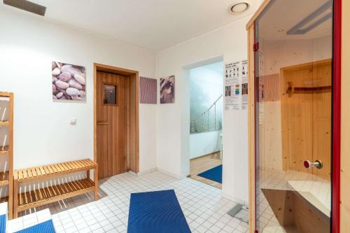 a bathroom with a shower and a door at Comfort Hotel Atlantic Muenchen Sued in Ottobrunn