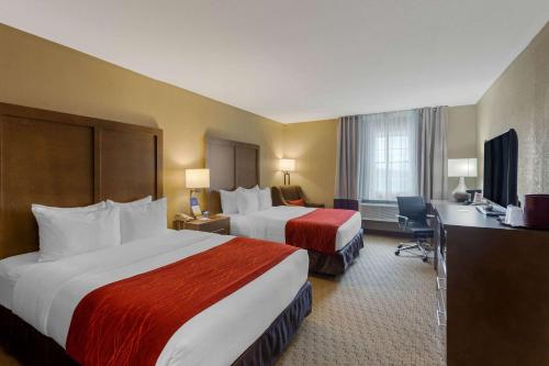 a hotel room with two beds and a desk at Comfort Inn Marshall Station in Marshall