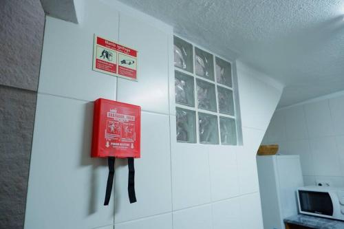 a red sign on a wall in a room at A Casinha dos Avós João e Ana in Escalos de Cima
