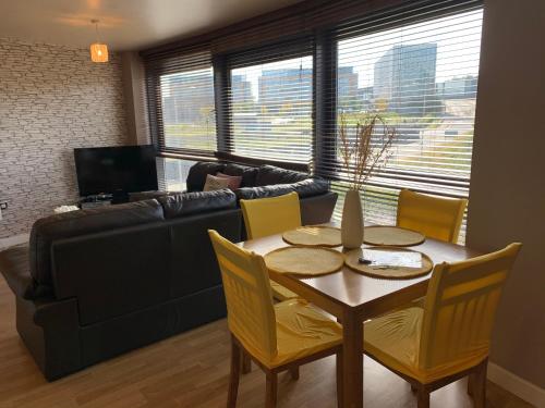 a living room with a table and a couch at Millennium Apartments in Newcastle upon Tyne
