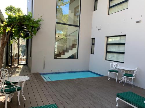 a patio with a pool in the middle of a house at Just Joey Lodge in Stellenbosch