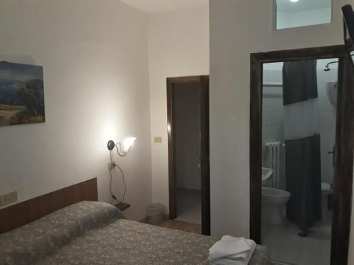 Ένα ή περισσότερα κρεβάτια σε δωμάτιο στο Hotel La Torretta