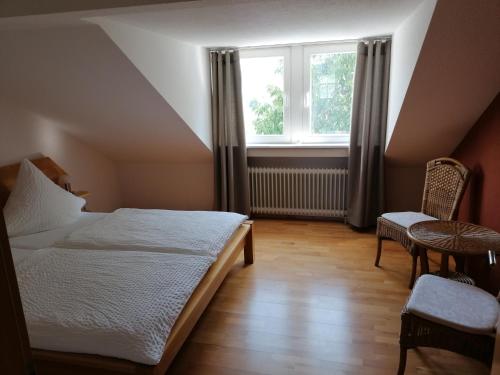 a bedroom with a bed and a window and a chair at Ferienwohnung in Riol