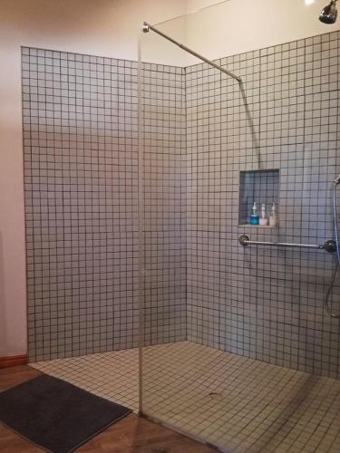 a shower with a glass door in a bathroom at Montagu Ronda-View in Montagu