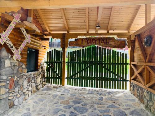 an entrance to a wooden gate with a stone wall at Kuća za odmor Bajka in Jastrebarsko
