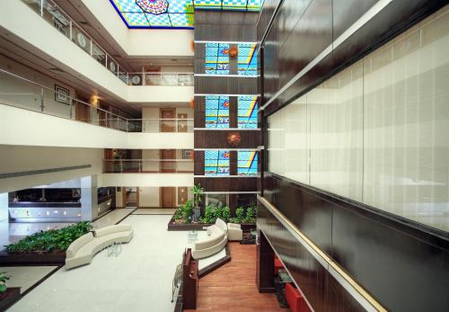 a hospital lobby with chairs and stained glass windows at Ramada Qurum Beach Hotel in Muscat