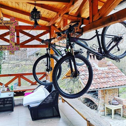 a bike is hanging from a wooden roof at Kuća za odmor Bajka in Jastrebarsko