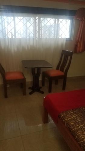 a room with two chairs and a table and window at Ocean View Nyali Boutique Hotel in Nyali