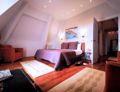 a bedroom with a bed and a living room at Chateau Mont Joly in Gan