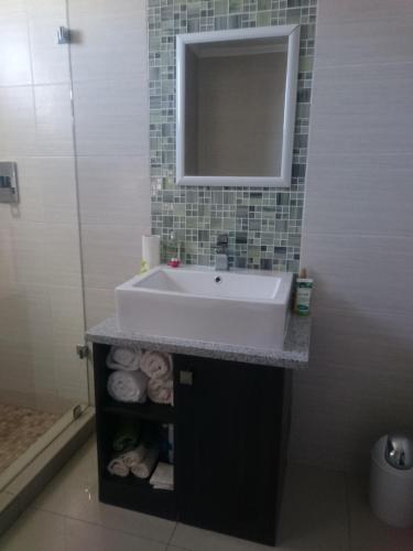 a bathroom with a sink and a mirror at Lifestyle Apartments in Gaborone