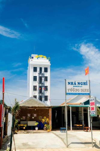 a large white building with a sign in front of it at Châu Ngọc Viên Hotel - Biển Mỹ Khê - Quảng Ngãi in Quang Ngai