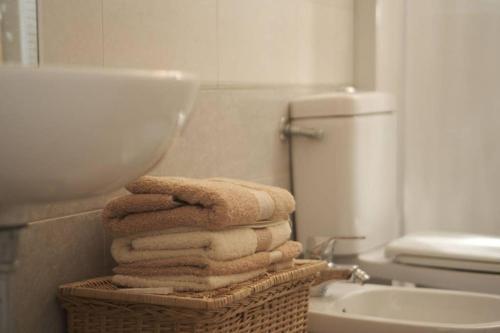 a pile of towels in a bathroom with a sink at La capannina in Modena