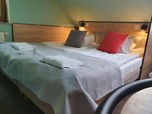 two beds with pillows on them in a room at Chata nad Sztolnią in Bystrzyca Górna