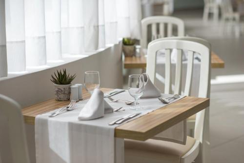 a table with a white table cloth and glasses on it at Iberostar Waves Bouganville Playa in Adeje
