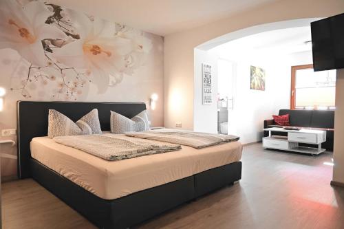 a bedroom with a large bed and a television at Appartement Wanneck in Biberwier