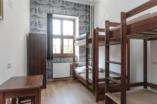 
a room with a bunk bed and a desk at MoHo E Hostel in Wrocław

