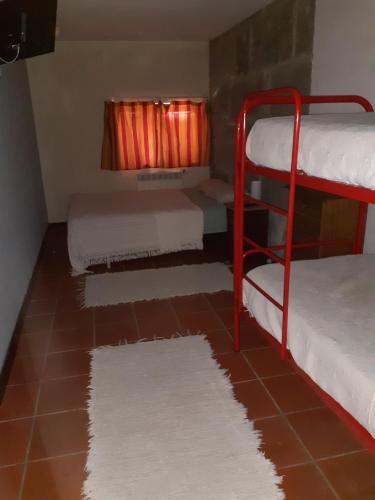 a room with two bunk beds and a rug at Stone Farm Hostel in Felgueiras