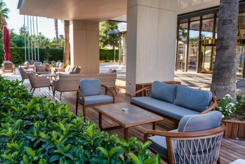 a living room filled with furniture and a patio at Oz Hotels Antalya Resort & Spa Adult 9 in Antalya