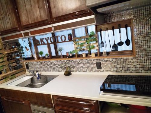 a kitchen with a sink and a counter with utensils at Kyoto Villa Kotone in Kyoto