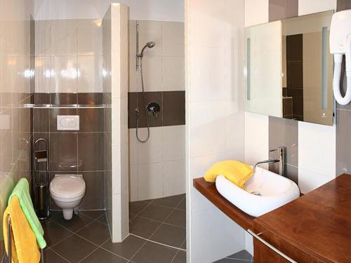 a bathroom with a shower and a sink and a toilet at Villa Simone in Žbandaj